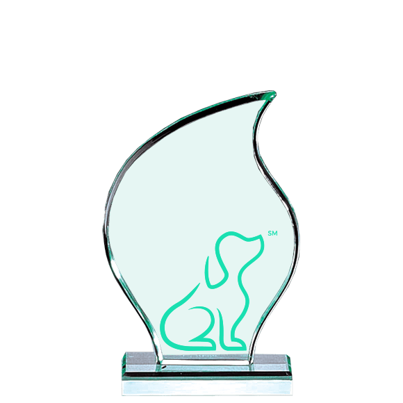 A green glass award with a dog on it.